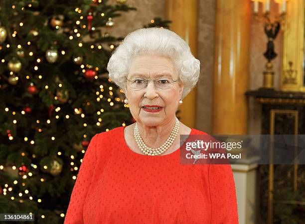 Queen Elizabeth II stands in the 1844 Room of Buckingham Palace after recording her annual Christmas Day television broadcast to the Commonwealth on...