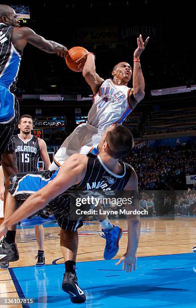Russell Westbrook of the Oklahoma City Thunder is called for charging against Ryan Anderson of the Orlando Magic during an NBA game on December 25,...