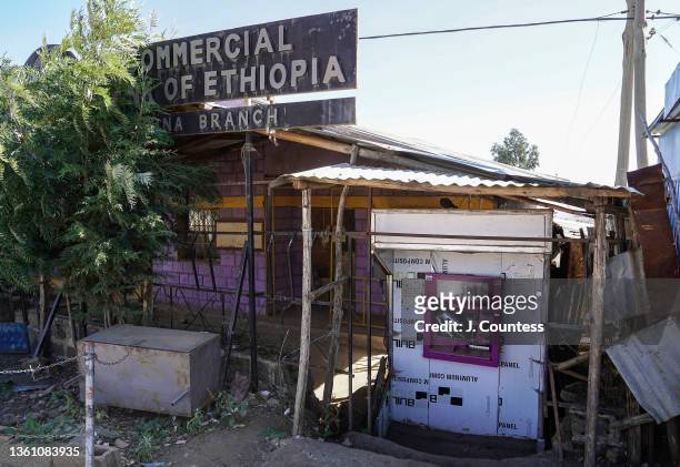Damaged ATM machine which had been looted by the TPLF sits in front of a shuttered Commerical Bank of Ethiopia on December 23, 2021 in Ayna Eyesus,...