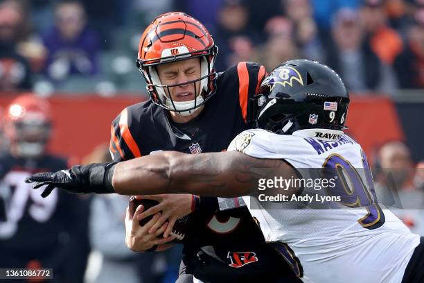 Joe Burrow of the Cincinnati Bengals avoids a sack from Broderick Washington of the Baltimore Ravens during the first quarter at Paul Brown Stadium...
