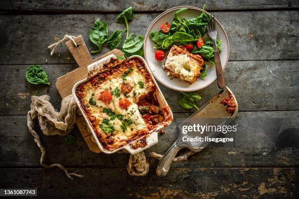 lasagna and spinach - rustic plate overhead stock pictures, royalty-free photos & images