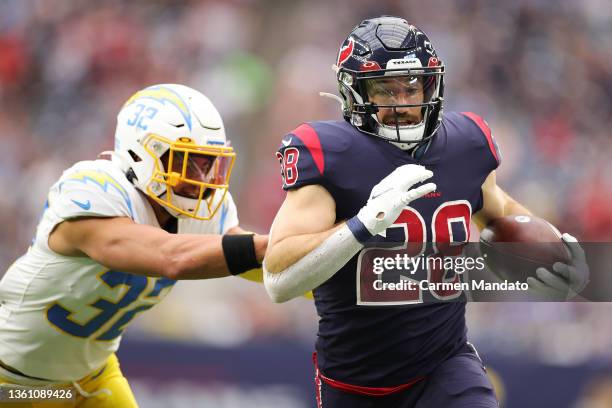 Rex Burkhead of the Houston Texans runs the ball for a touchdown in front of Alohi Gilman of the Los Angeles Chargers during the first quarter at NRG...