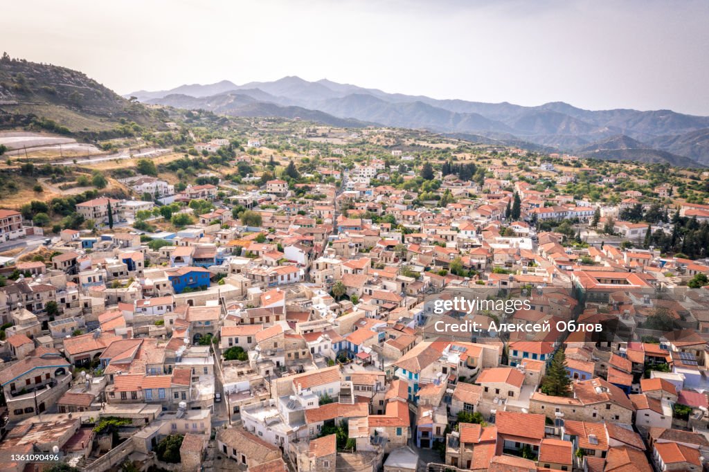Aerial view of famous landmark tourist destination valley Pano Lefkara village, Larnaca, Cyprus. Ceramic tiled house roofs, greek orthodox church at south of Troodos hills, Kionia, from above