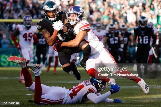 DeVonta Smith of the Philadelphia Eagles is tackled by Julian Love of the New York Giants during the second quarter at Lincoln Financial Field on...
