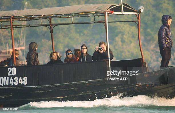 This picture taken on December 25, 2011 shows Facebook's founder and billionaire Mark Zuckerberg and his girlfriend Priscilla Chan touring Ha Long...
