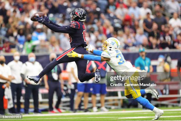 Chris Moore of the Houston Texans catches the ball over Essang Bassey of the Los Angeles Chargers during the fourth quarter at NRG Stadium on...