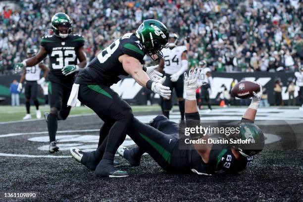 Conor McDermott of the New York Jets celebrates a touchdown with Nick Bawden of the New York Jets during the fourth quarter in the game against the...