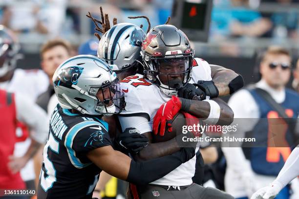 Henderson of the Carolina Panthers tackles Ronald Jones of the Tampa Bay Buccaneers during the fourth quarter at Bank of America Stadium on December...