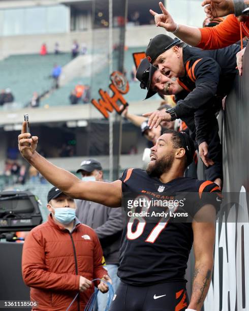 Uzomah of the Cincinnati Bengals celebrates with fans after a win over the Baltimore Ravens at Paul Brown Stadium on December 26, 2021 in Cincinnati,...