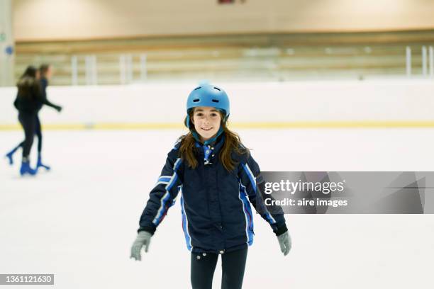 little girl learning to skate on ice rink. portrait of little girl learning to skate on ice rink. sport concept. - ice rink stock pictures, royalty-free photos & images