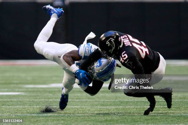 Jamaal Williams of the Detroit Lions makes a catch against Deion Jones of the Atlanta Falcons in the first half at Mercedes-Benz Stadium on December...