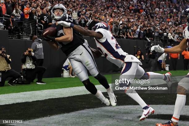 Hunter Renfrow of the Las Vegas Raiders catches a touchdown pass in the end zone against Kareem Jackson of the Denver Broncos in the second quarter...