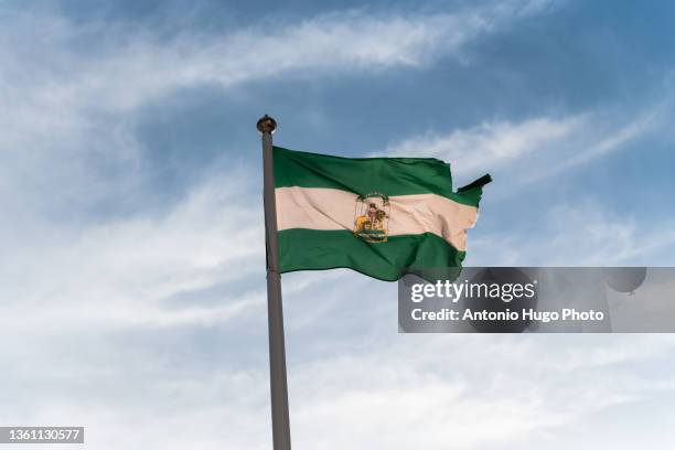 andalusian flag waving - andalucia stock pictures, royalty-free photos & images