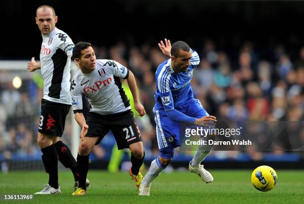 Jose Bosingwa of Chelsea goes past Danny Murphy and Kerim Frei of Fulham during the Barclays Premier League match between Chelsea and Fulham at...