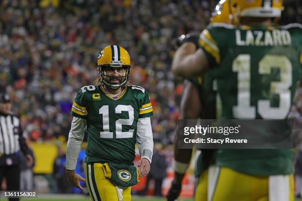Aaron Rodgers of the Green Bay Packers reacts to a touchdown during a game against the Cleveland Browns at Lambeau Field on December 25, 2021 in...