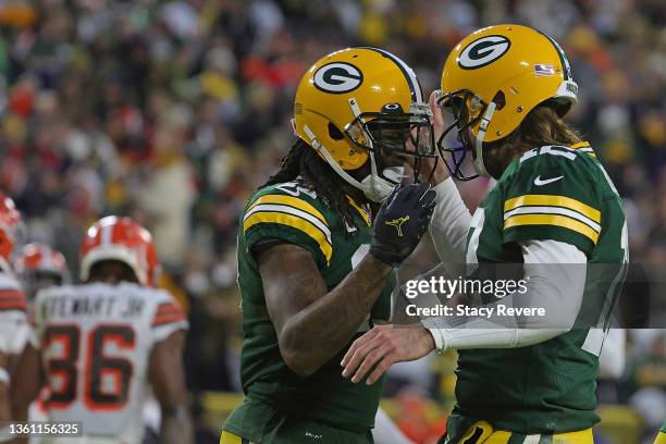 Aaron Rodgers celebrates a touchdown with Davante Adams of the Green Bay Packers during a game against the Cleveland Browns at Lambeau Field on...