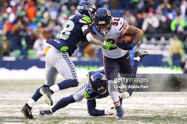 David Montgomery of the Chicago Bears runs the ball and is tackled by Ugo Amadi and John Reid of the Seattle Seahawks during the fourth quarter at...