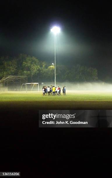 group of boys in football pitch - football pitch night stock pictures, royalty-free photos & images