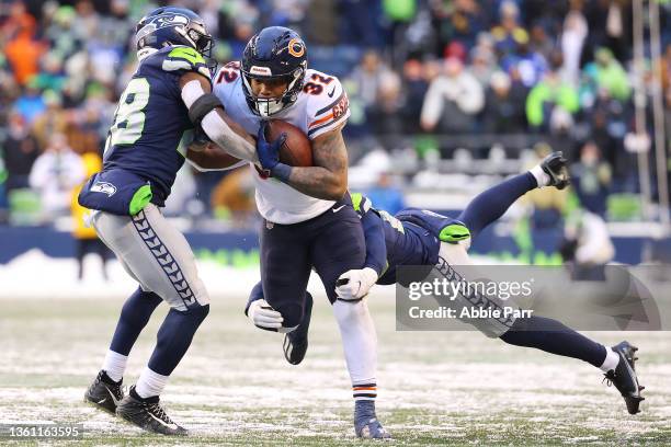 David Montgomery of the Chicago Bears runs the ball and is tackled by Ugo Amadi and John Reid of the Seattle Seahawks during the fourth quarter at...