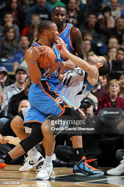 Russell Westbrook of the Oklahoma City Thunder knocks over Jose Juan Barea of the Minnesota Timberwolves as he drives to the basket during the first...