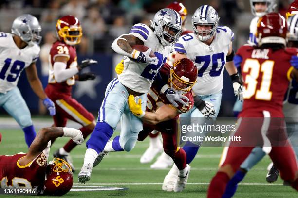 Ezekiel Elliott of the Dallas Cowboys rushes with the ball during the first half against the Washington Football Team at AT&T Stadium on December 26,...