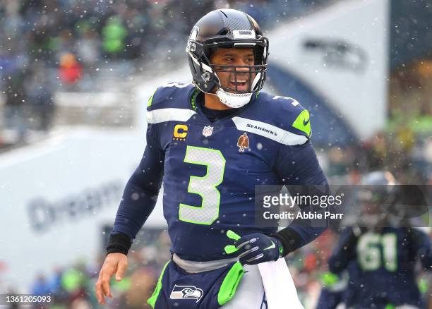 Russell Wilson of the Seattle Seahawks reacts after Rashaad Penny scores a touchdown during the second quarter against the Chicago Bears at Lumen...