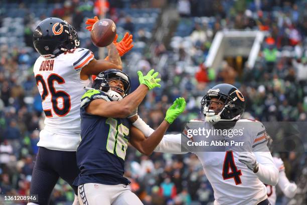 Deon Bush and Eddie Jackson of the Chicago Bears break up a pass intended for Tyler Lockett of the Seattle Seahawks during the third quarter at Lumen...