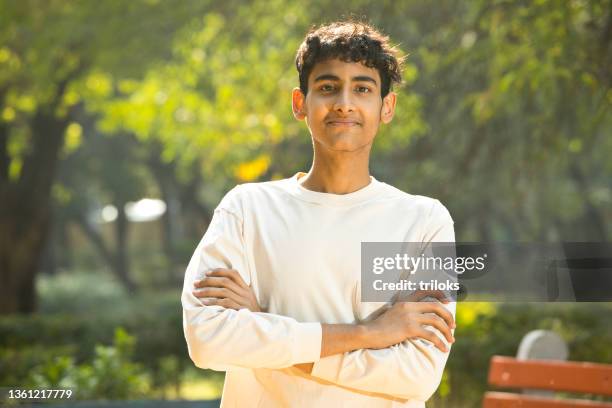 portrait of happy teenage boy at park - teenager boy stock pictures, royalty-free photos & images