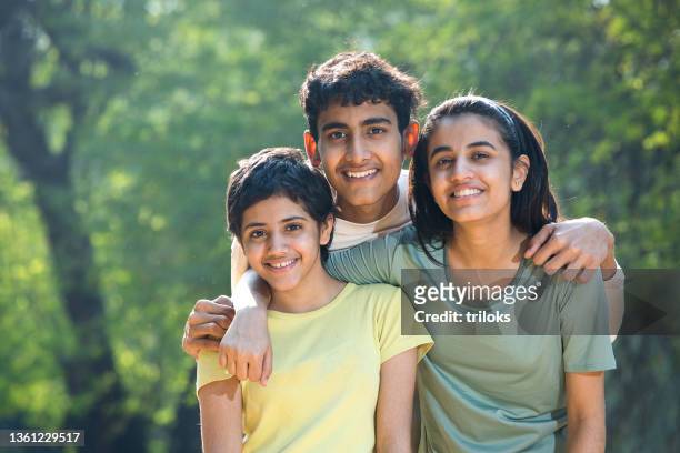 portrait of teenagers having fun at park - indian sibling stock pictures, royalty-free photos & images