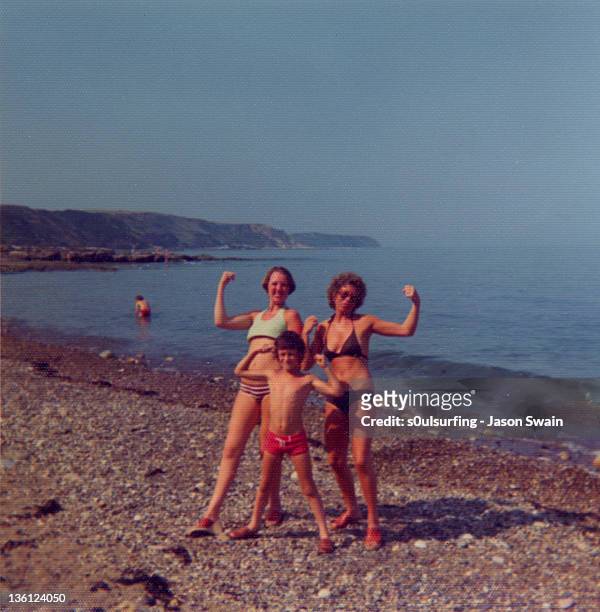 family holiday fun on beach - di archivio foto e immagini stock