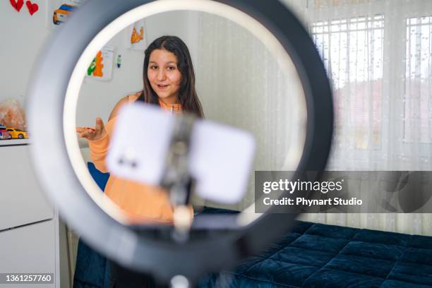 side view portrait of teenage  girl filming videos at home and dancing to camera set on ring light, young blogger concept, copy space - girl camera bildbanksfoton och bilder