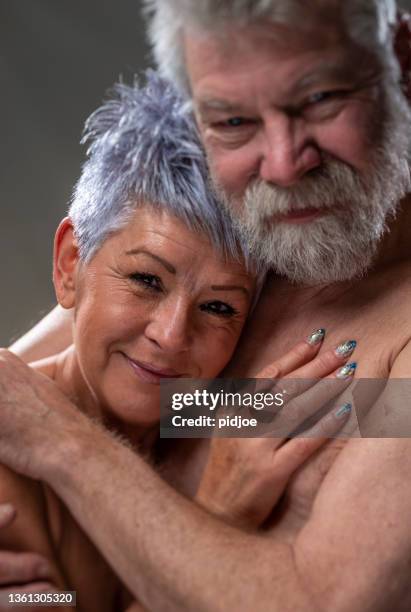 senior portrait, couple embracing each other, smiling. - old woman tattoos stock pictures, royalty-free photos & images