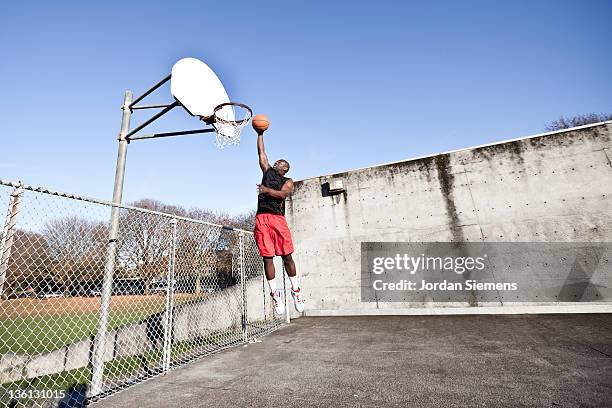 african american man playing basketball. - slam dunk stock pictures, royalty-free photos & images