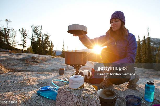 a female enjoying sunrise at her camp site. - camp site stock-fotos und bilder