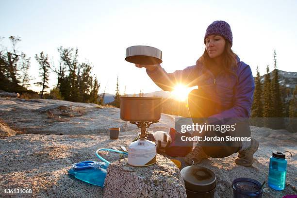 a female enjoying sunrise at her camp site. - gas stove stock pictures, royalty-free photos & images