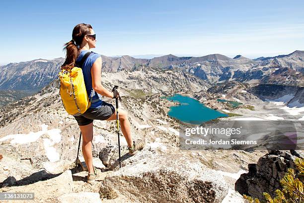 a female backpacking in the mountains. - hiking pole stock pictures, royalty-free photos & images