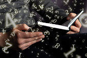numerology, a man holds an open book in his hands, surrounded by numbers
