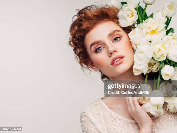 beautiful girl with tulips - beautiful redhead stockfoto's en -beelden