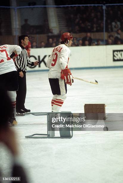Paul Henderson of Canada skates by a chair thrown onto the ice by Canadian coach Harry Sinden ,) after the referees made some questionable calls...
