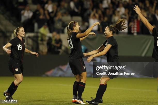 Alex Morgan of the United States is hoisted by Lauren Cheney after scoing a goal against Canada on September 22, 2011 at Jeld-Wen Field in Portland,...