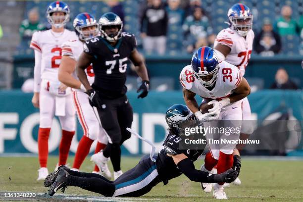 Alex Singleton of the Philadelphia Eagles tackles Elijhaa Penny of the New York Giants at Lincoln Financial Field on December 26, 2021 in...