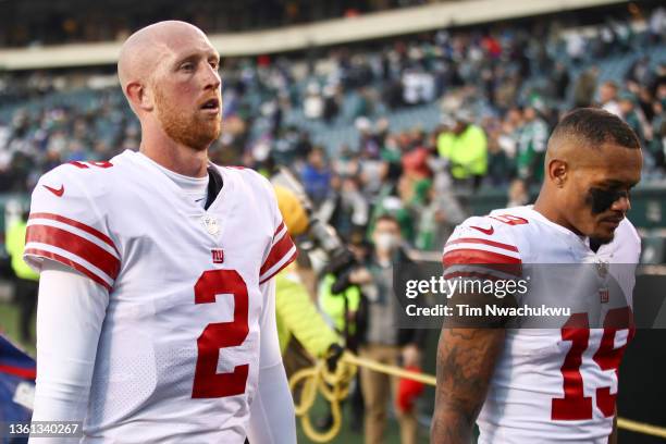 Mike Glennon and Kenny Golladay of the New York Giants walk off the field against the Philadelphia Eagles at Lincoln Financial Field on December 26,...