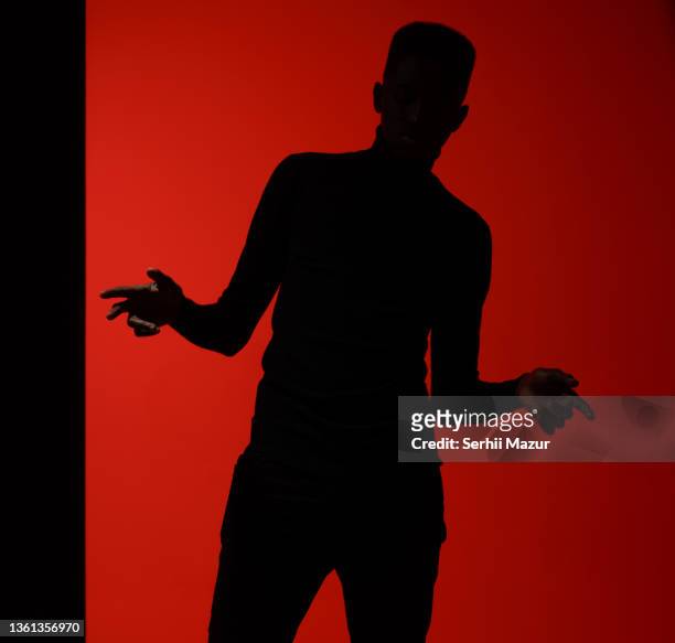 young adult man posing  in studio putting hand in the air- stock photo - mockup identity stock pictures, royalty-free photos & images