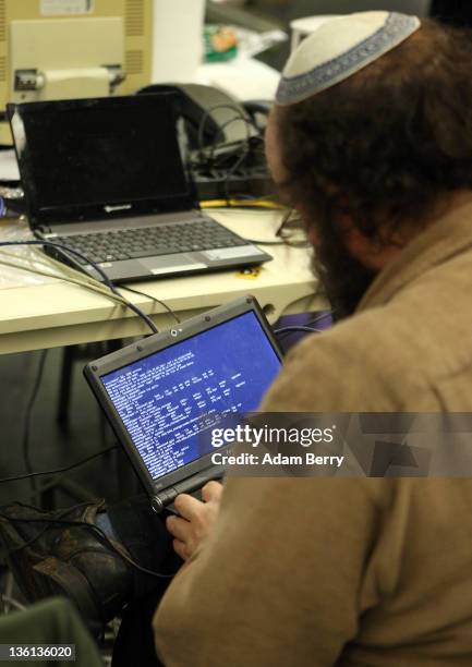 Participant works on a laptop on the first day of the 28th Chaos Communication Congress - Behind Enemy Lines computer hacker conference on December...