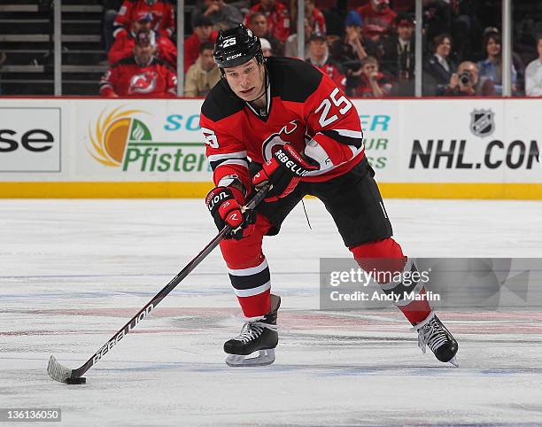 Cam Janssen of the New Jersey Devils plays the puck against the Washington Capitals during the game at the Prudential Center on December 23, 2011 in...