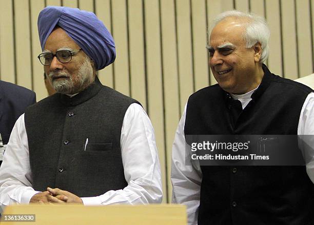 Prime Minister Manmohan Singh and Union Human Resource Development Minister Kapil Sibal attend a function to commemorate the 150th Birth Anniversary...