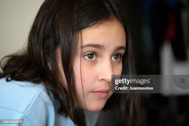 pensive little girl looking away - autismus stock pictures, royalty-free photos & images