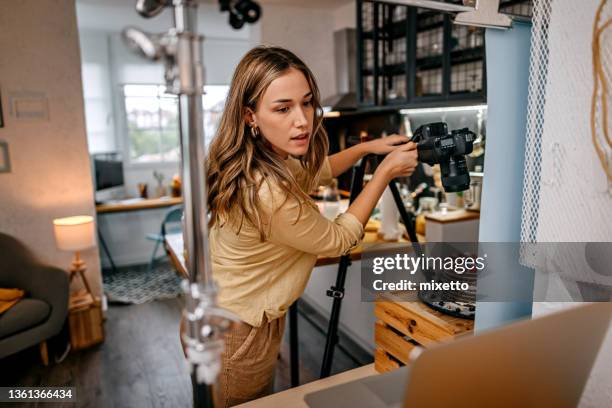 blogger clicking food picture and checking setting on laptop - photo shoot studio stock pictures, royalty-free photos & images