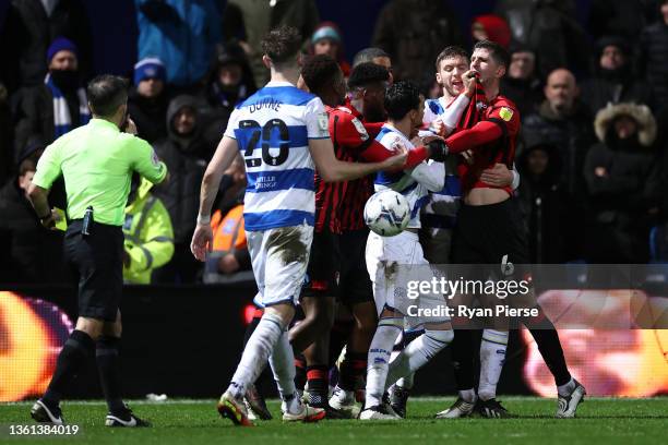 Andre Dozzell of Queens Park Rangers, Chris Mepham of AFC Bournemouth and teammates clash during the Sky Bet Championship match between Queens Park...