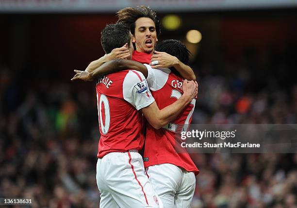 Gervinho celebrates scoring the Arsenal goal with Yossi Benayoun and Robin van Persie during the Barclays Premier League match between Arsenal and...